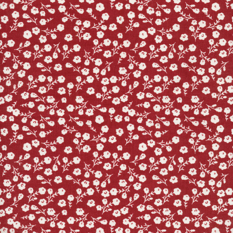This fabric features tossed white flowers with stems on a dark red background.