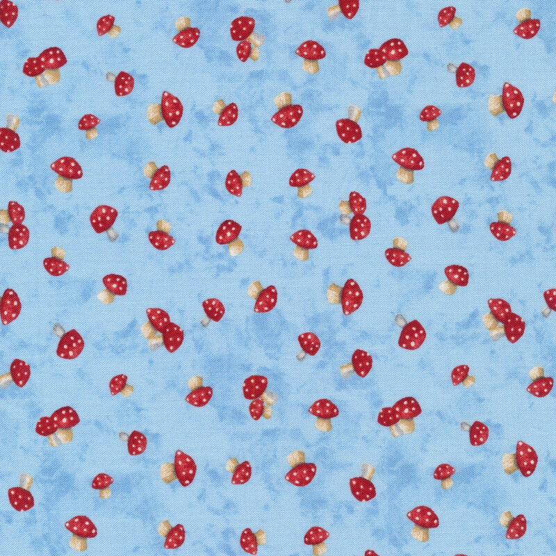 This fabric features tossed red and white mushrooms on pale blue mottled background.