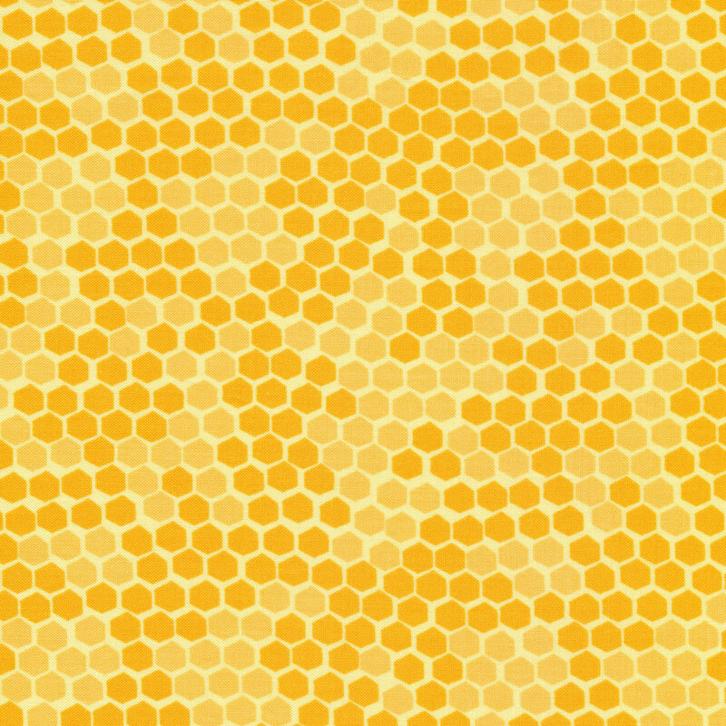 This fabric features a tonal yellow honeycomb print