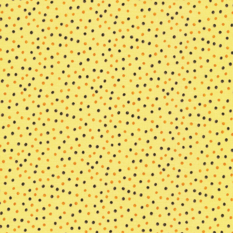 This fabric features black and orange watercolor dots on a yellow background