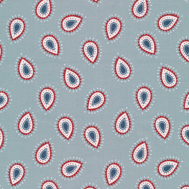 gray blue fabric featuring abstract droplet shapes in midnight blue, bright red, and white