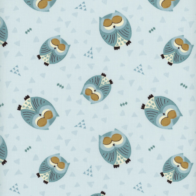 This fabric features tossed sleepy blue owls on a light blue background with tonal triangles.