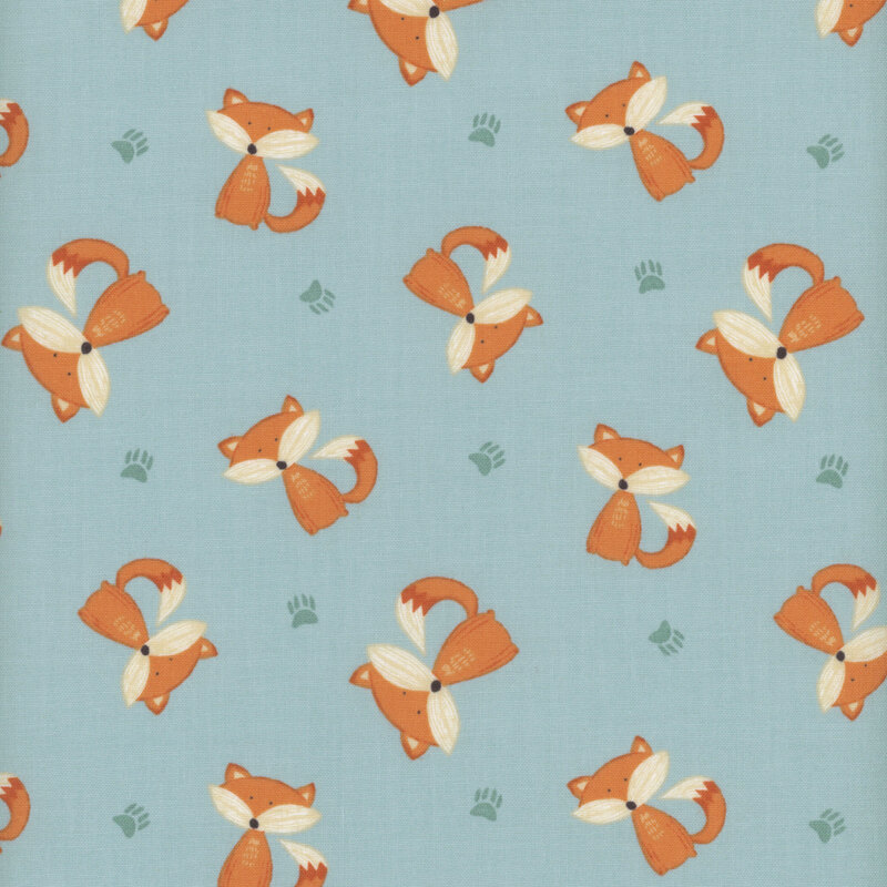 This fabric features tossed sitting foxes on a solid light blue background with dark blue paw prints.
