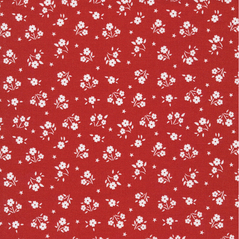 red fabric featuring tiny white flowers and stars