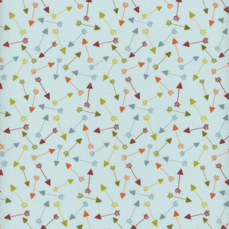 This fabric features tossed arrows in blue, brown, orange and green on a solid light blue background.