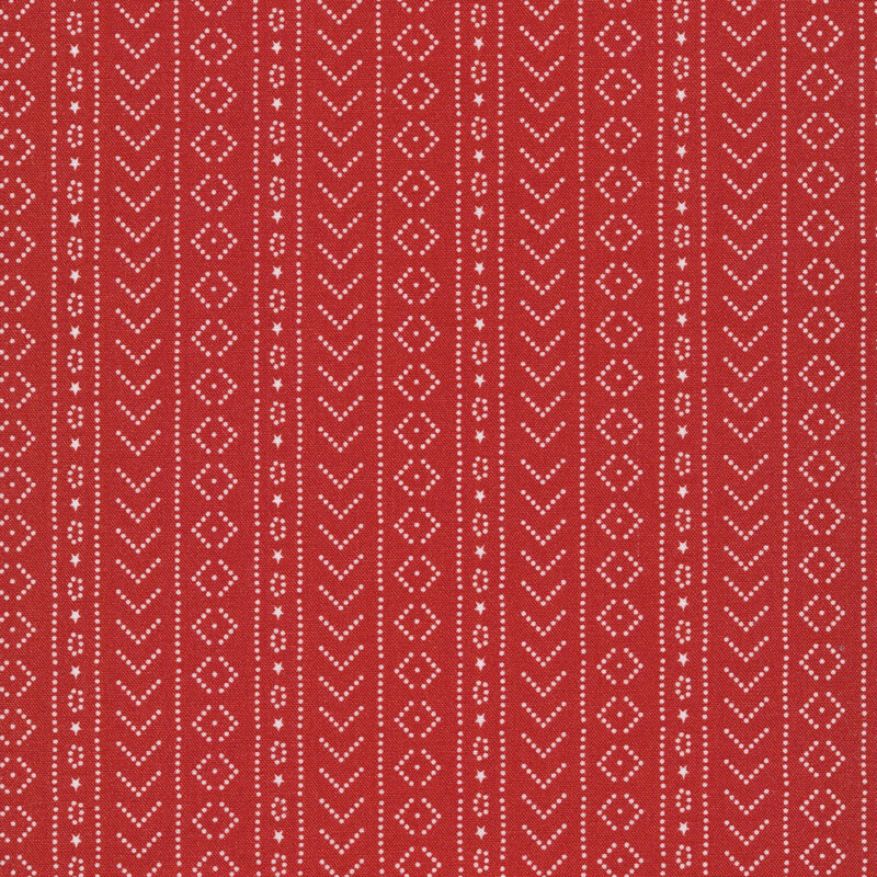 red fabric featuring white dots arranged in geometric shapes and stripes, and tiny stars