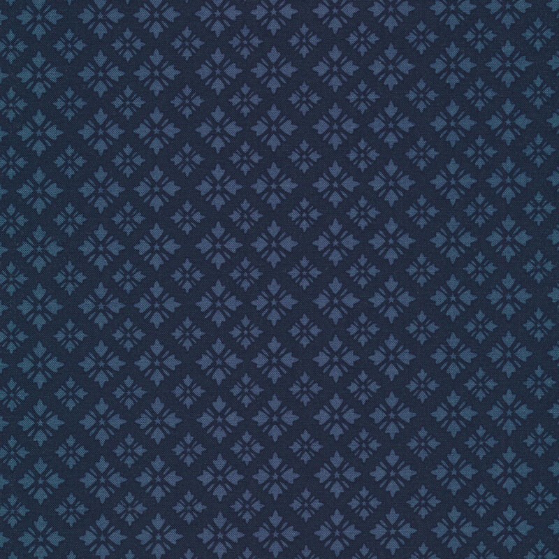 tonal midnight blue fabric featuring geometric shapes arranged in loose diamond designs with tiny stars at their centers