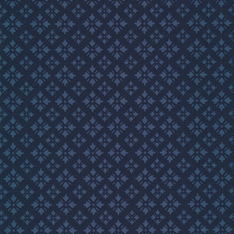 tonal midnight blue fabric featuring geometric shapes arranged in loose diamond designs with tiny stars at their centers