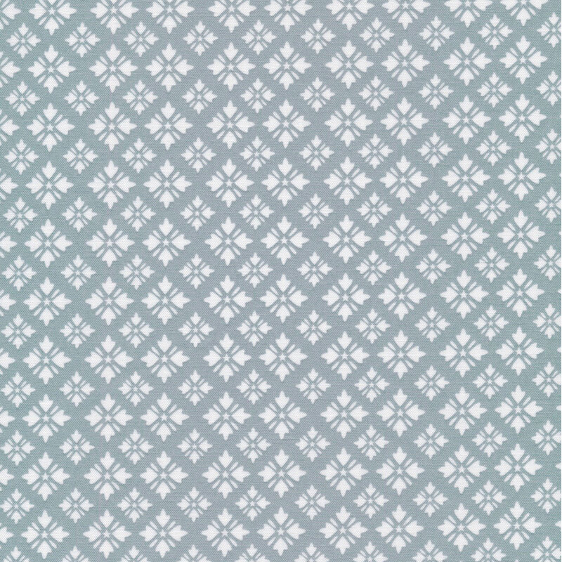 gray blue fabric featuring white geometric shapes arranged in loose diamond designs with tiny stars at their centers