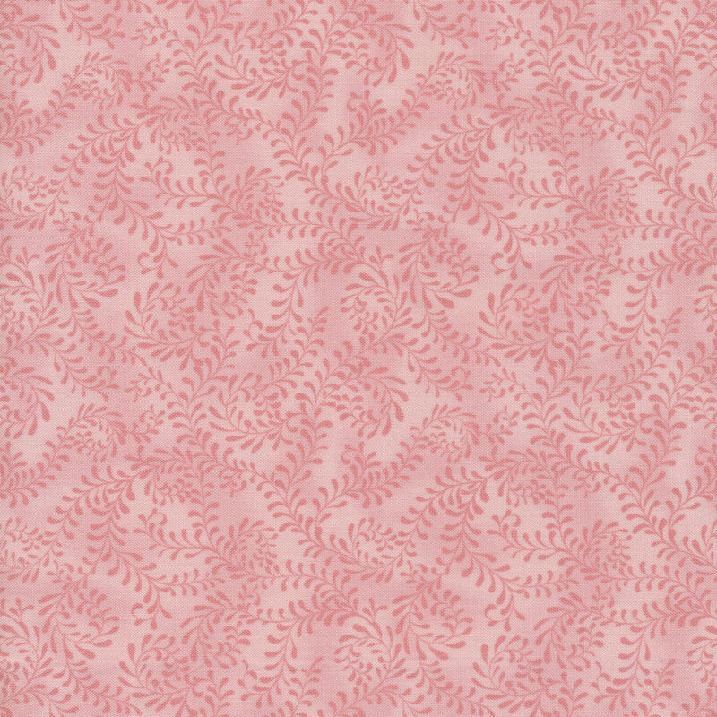 This fabric features a pink pattern of swirling leafy vines on a mottled blush pink background.