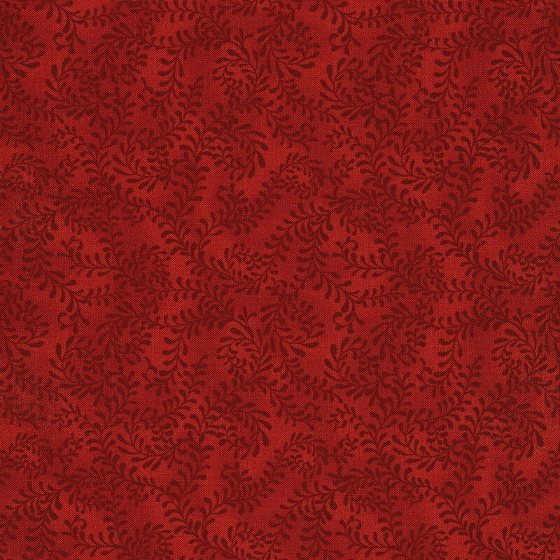 This fabric features a bright red pattern of swirling leafy vines on a mottled bold red background.