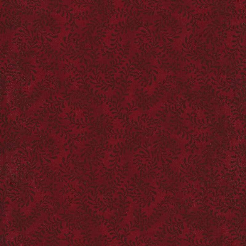 This fabric features a dark red pattern of swirling leafy vines on a mottled dark red background.