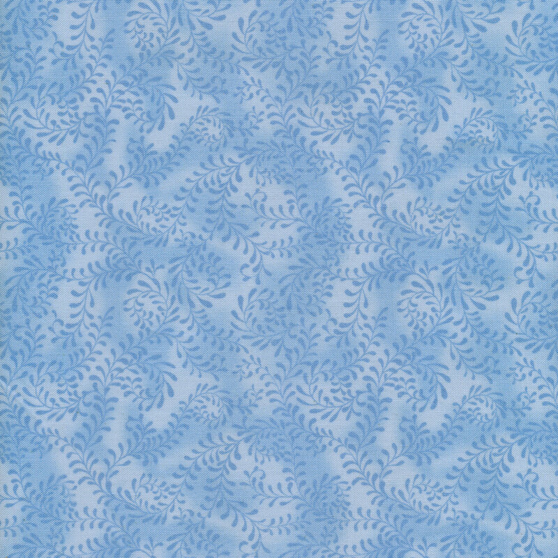 This fabric features a sky blue pattern of swirling leafy vines on a mottled blue background.