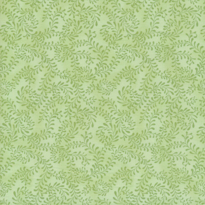 This fabric features a light green pattern of swirling leafy vines on a mottled pastel green background.