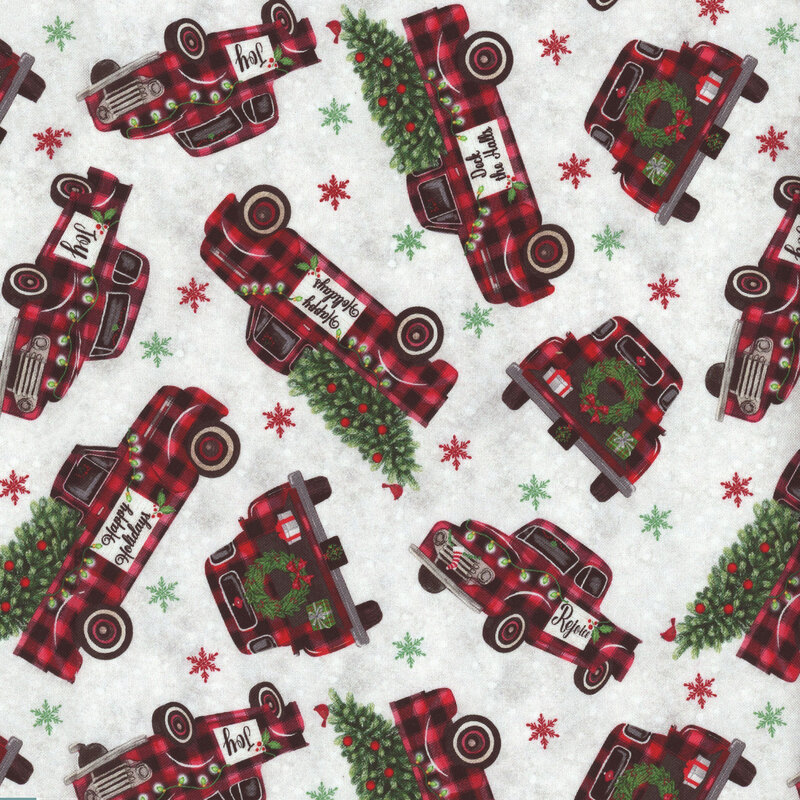fabric featuring tossed red and black gingham trucks on a mottled gray and white background with tossed green and red snowflakes