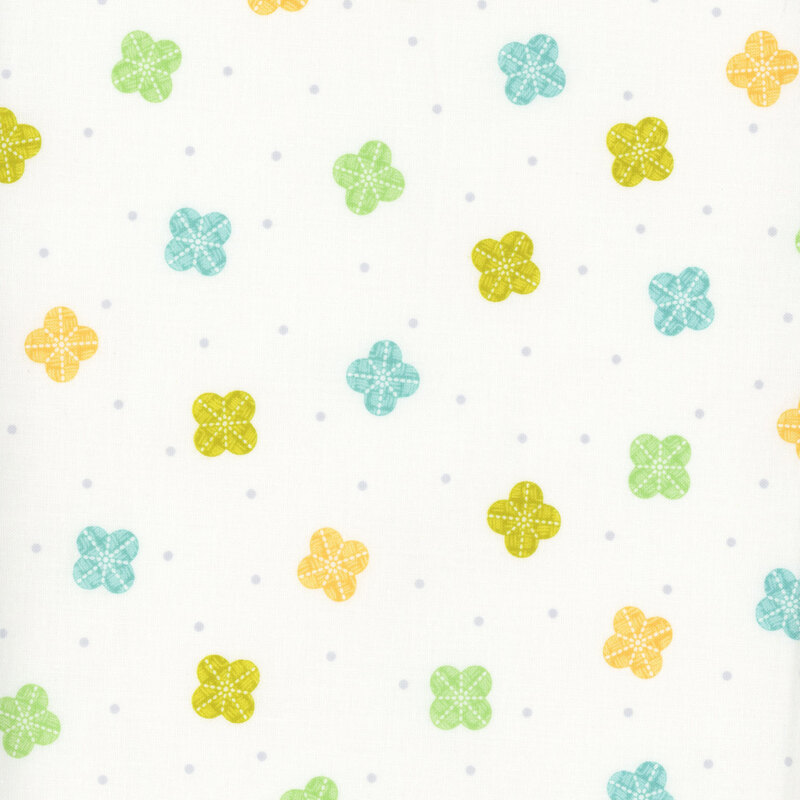 fabric featuring tossed scalloped flower-like motifs in green, turquoise, and yellow on a white background