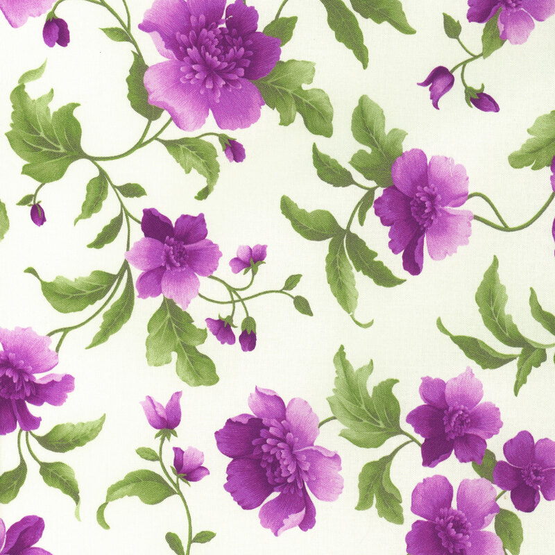 Fabric with purple flowers and bright green leaves on a solid cream background.