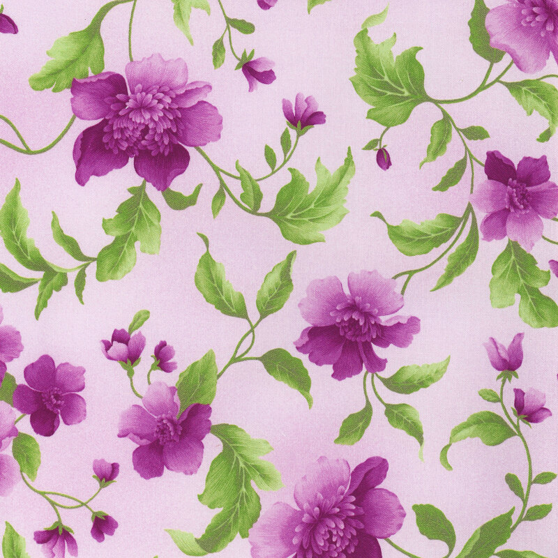 Fabric with purple flowers that have bright green leaves on a light purple background.