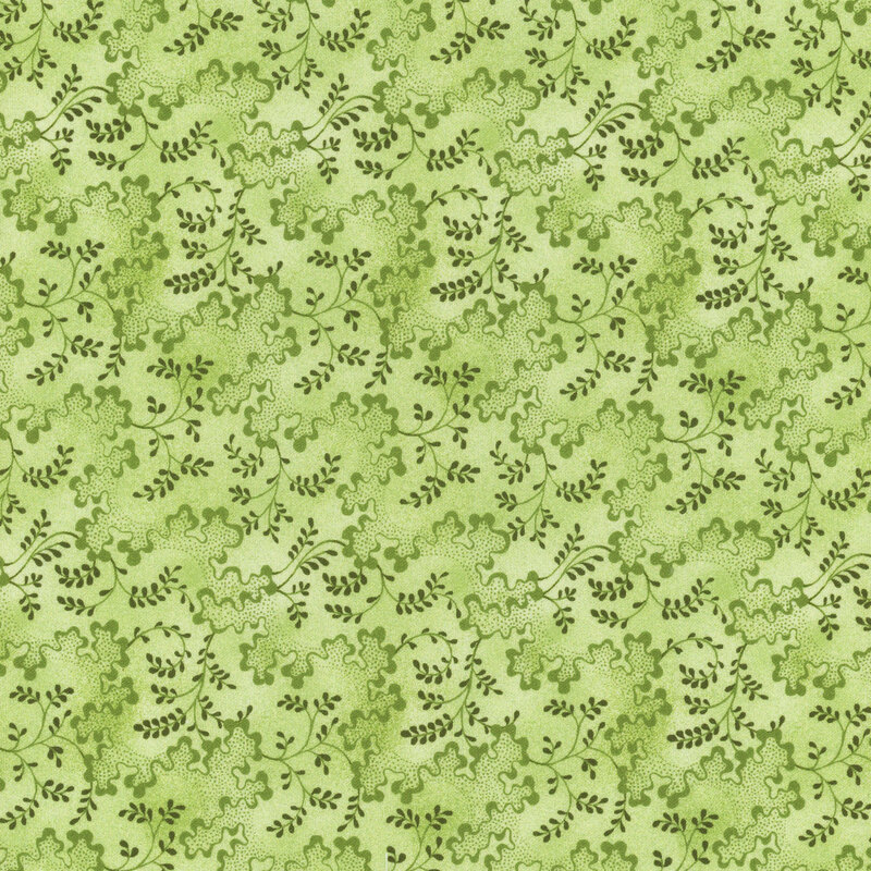 This fabric features tonal wavy lines with dots and scrolling green vines on a light green background.
