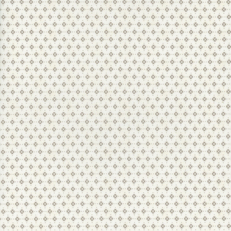 This fabric features clusters of beige clover motifs in rows on a solid cream background.