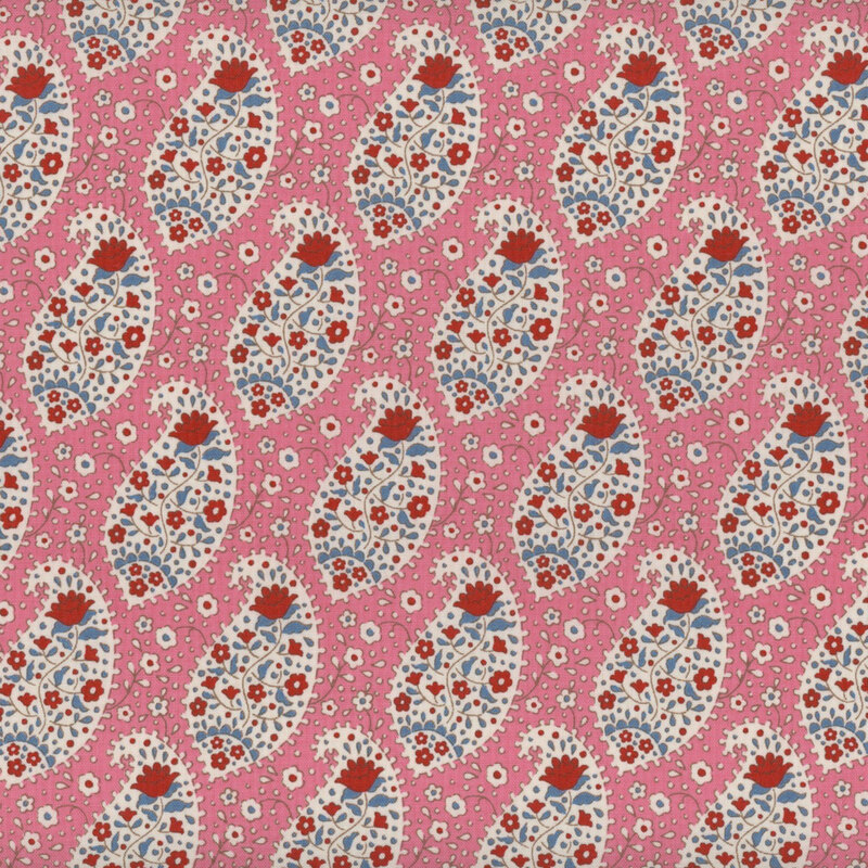 This fabric features red and blue florals within white paisley scrolls on a bright pink background.