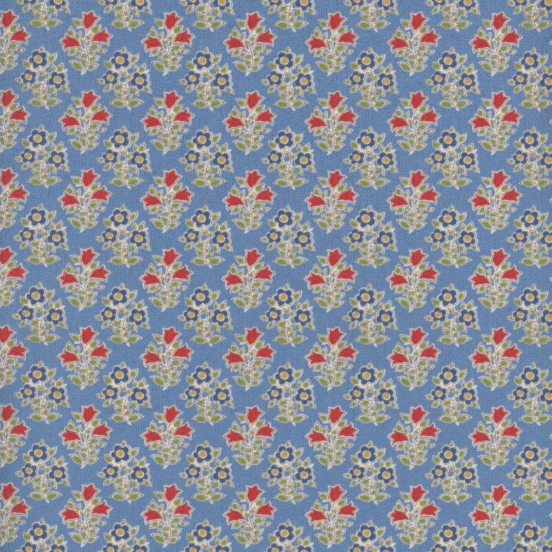 This fabric features a repeating print of blue flowers with yellow centers and red flowers, both with bright green leaves on a light dusty blue background.