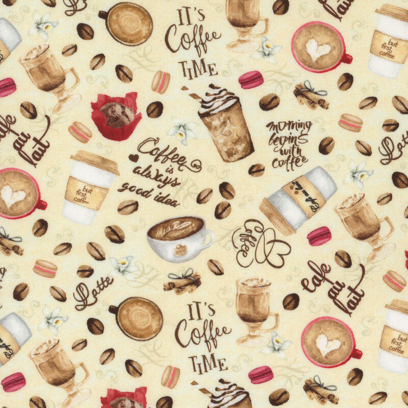 cream fabric covered in coffee cups, coffee beans, macarons, cinnamon sticks, and vanilla flowers