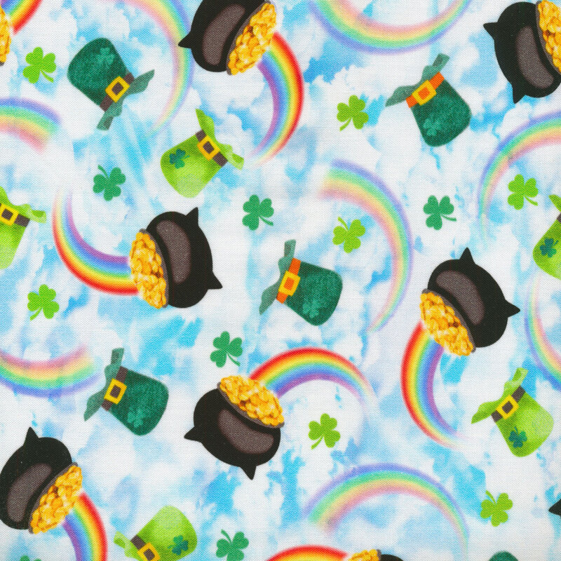 Sky blue fabric with white clouds, rainbows, pots of gold, and green leprechaun hats tossed all over.