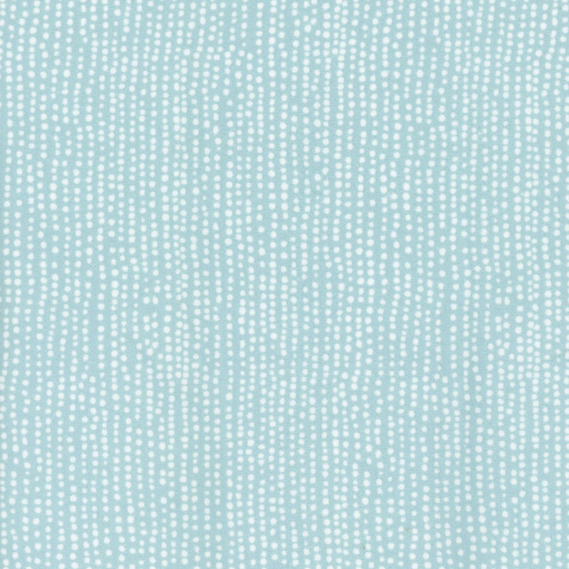 flannel fabric featuring rows of white dots on a light aqua background