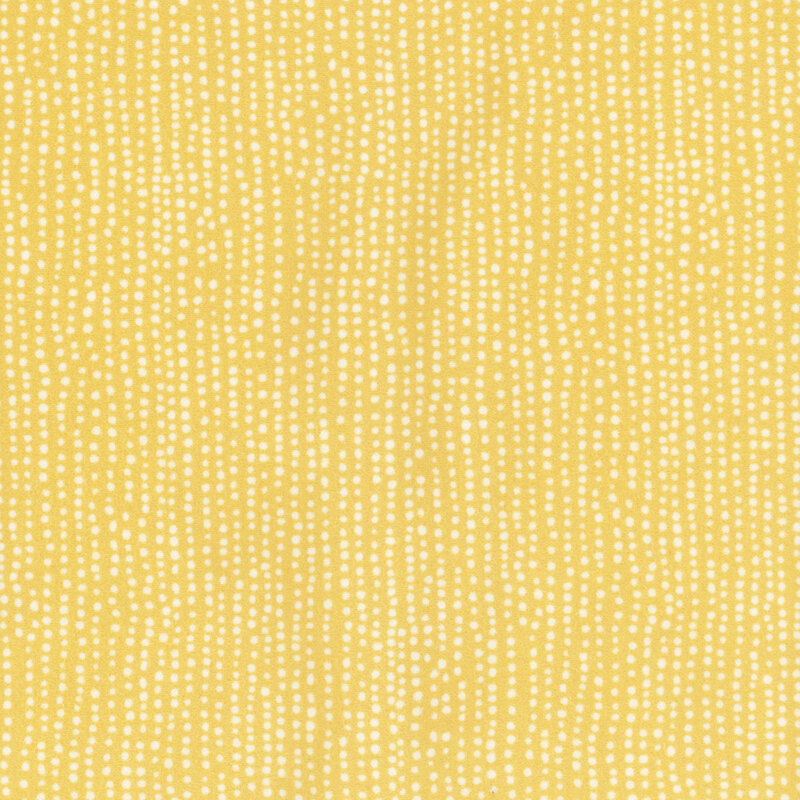 flannel fabric featuring rows of white dots on a dainty pastel yellow background