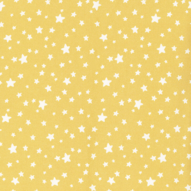 flannel fabric featuring adorable ditsy tossed white stars on a dainty pastel yellow background