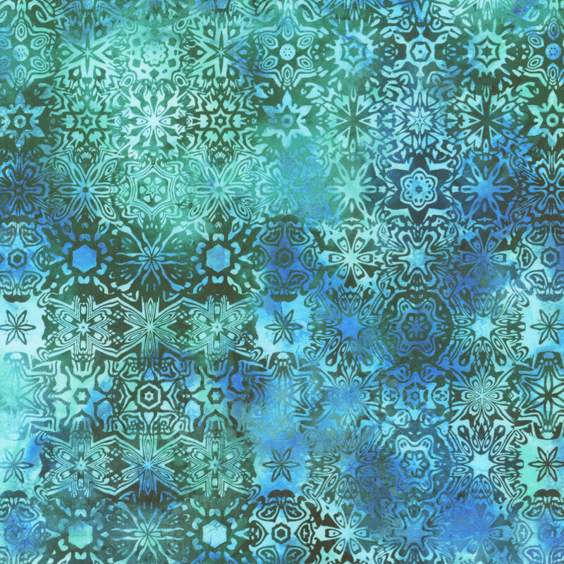 This fabric features a small kaleidoscope pattern in a mottled green, aqua, and blue colors.