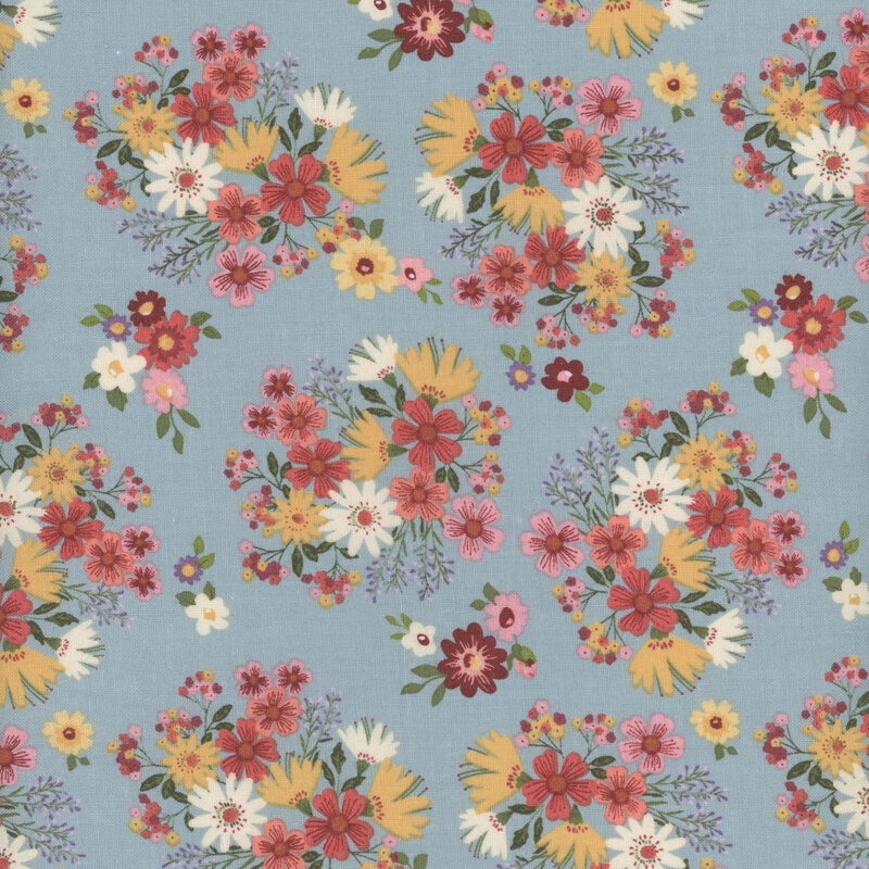 fabric featuring adorable clusters of burnt red, pink, golden yellow and cream flowers with sage green leaves on a solid light baby blue background.