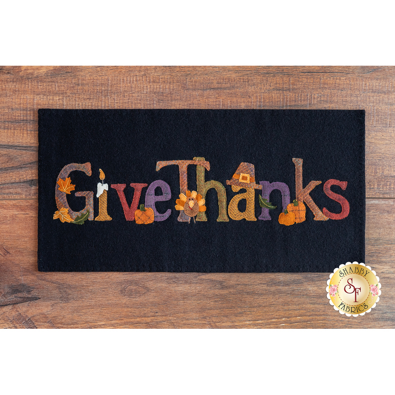 A black wool mat with the applique words 