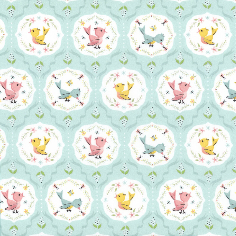fabric featuring white motifs with pink, yellow and blue songbirds on a light aqua background with dusty blue ribbon accents.