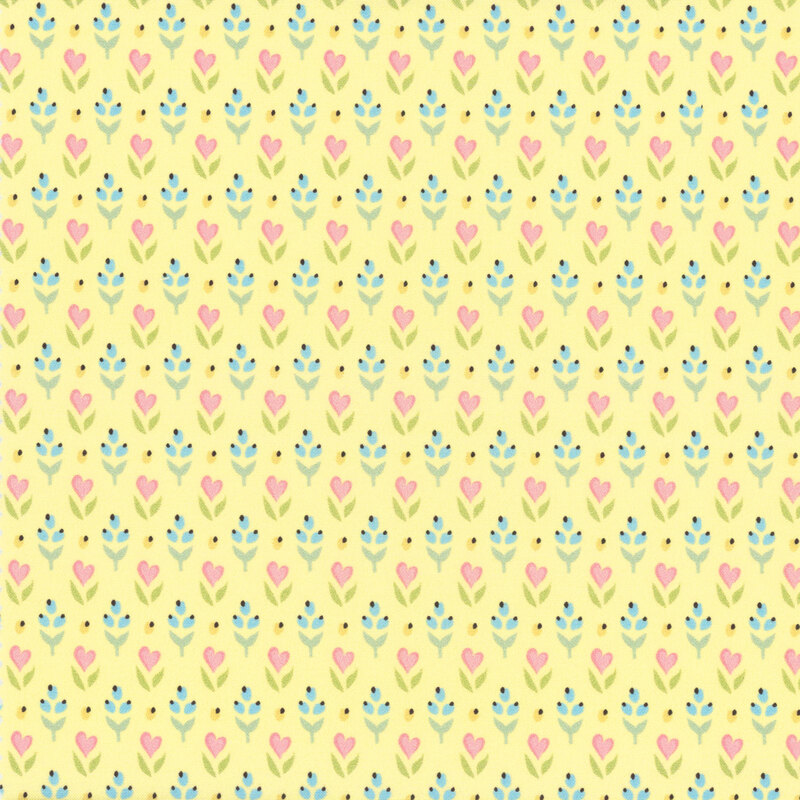 fabric featuring light blue and yellow buds with pink flowers shaped like pink hearts on a lovely pastel yellow background.