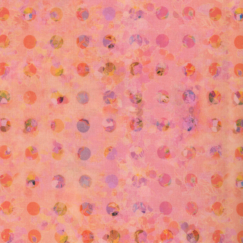 This fabric features a kaleidoscope pattern of pink, purple and yellow polka dots on a warm pink and peach background.