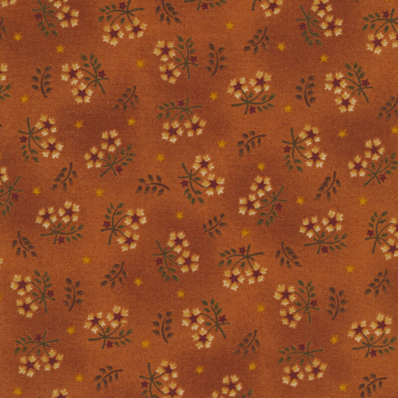 Fabric with tossed floral sprigs against a mottled burnt orange background