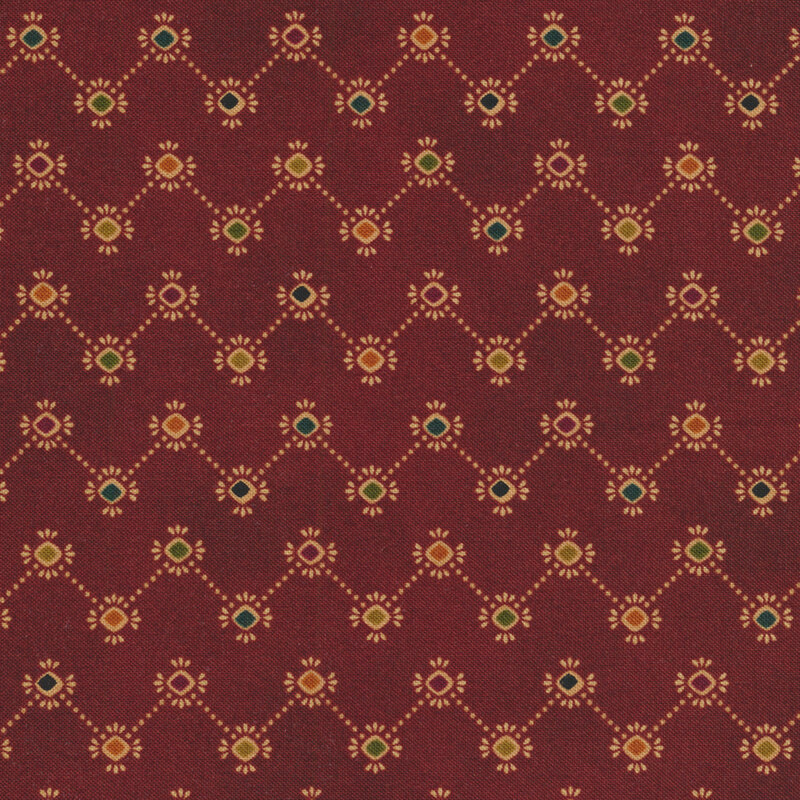 Dark red fabric with a dotted zig zag pattern with colorful diamond corners