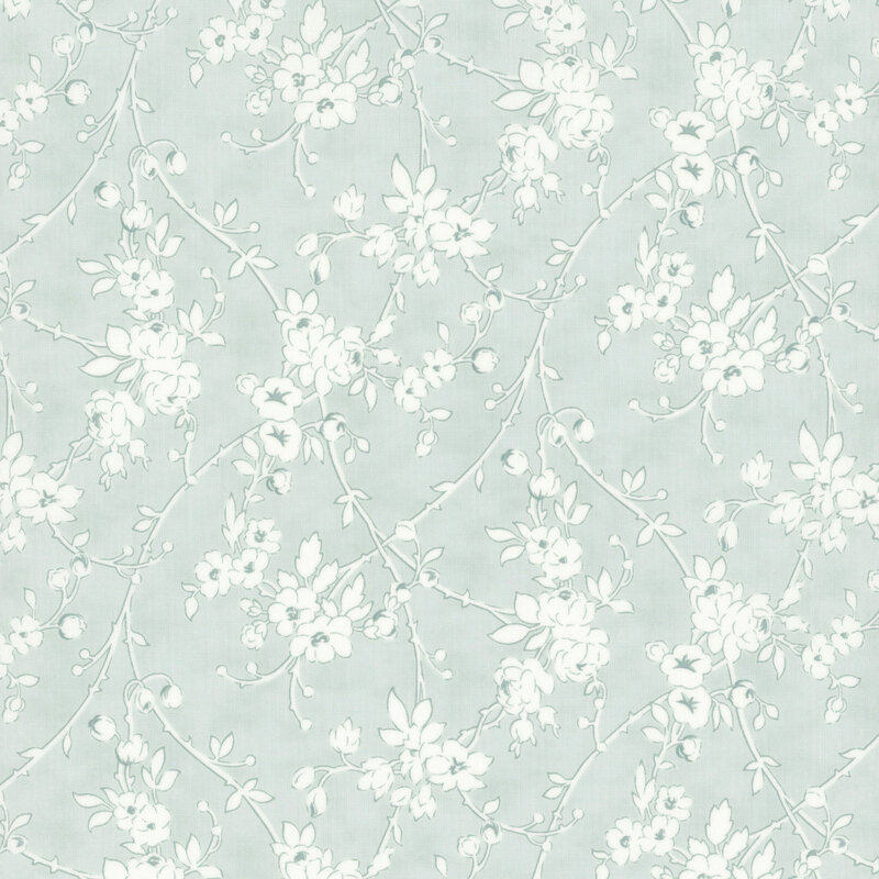 pastel blue fabric featuring weaving white vines with flowers
