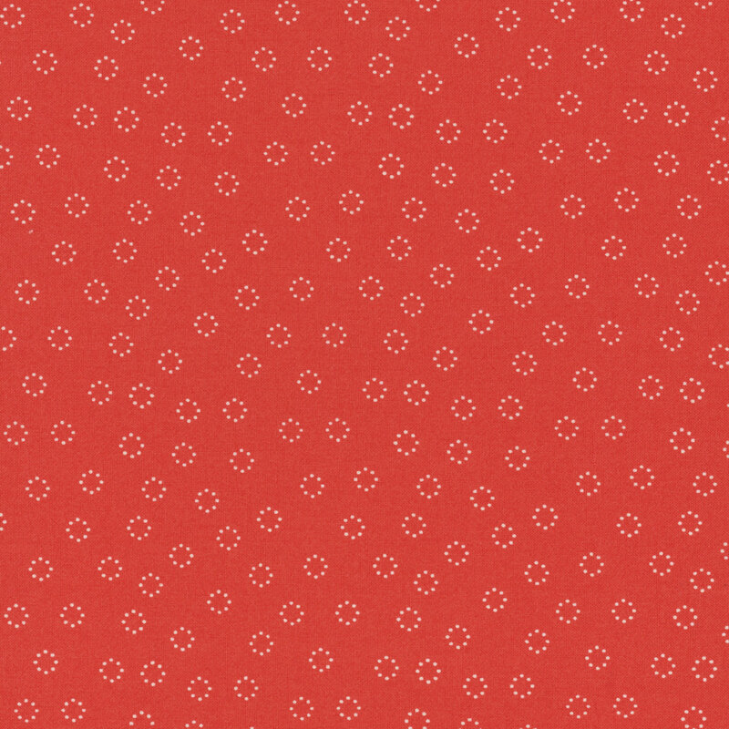 fabric featuring cream white dotted circles tossed on a solid bold red-pink background.