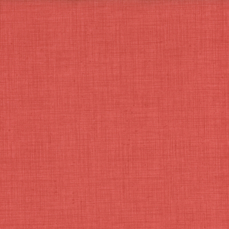 fabric featuring a lovely solid faded red print with a woven texture.