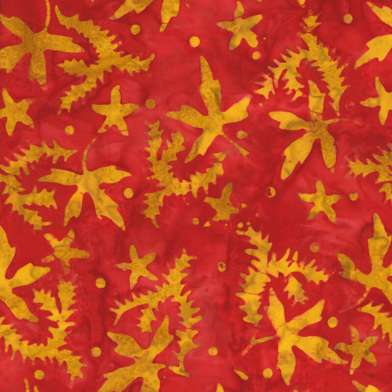 vibrant red mottled fabric featuring scattered mustard yellow mottled leaves and dots