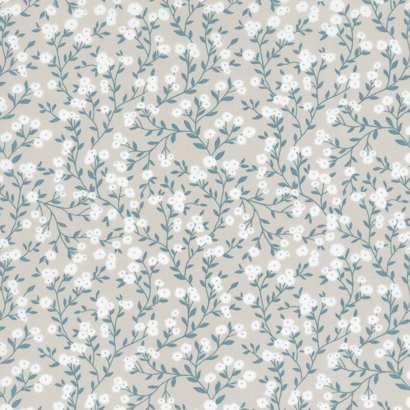 fabric featuring dusty blue spreading vines with crisp white flowers on a solid gray background.
