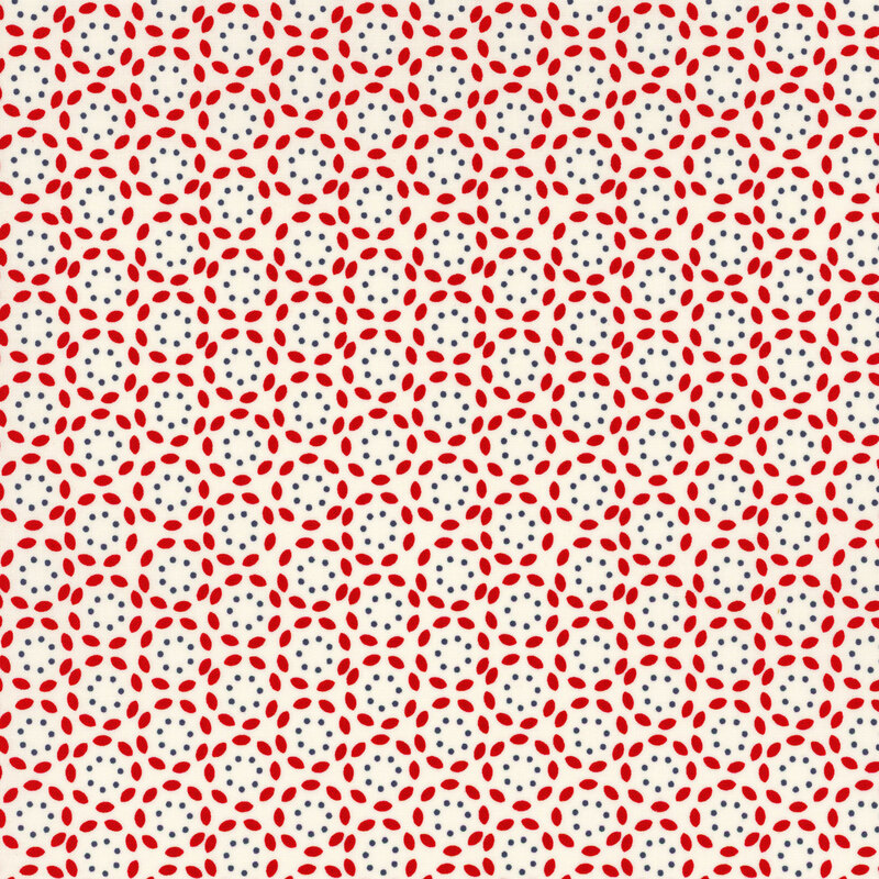 cream fabric featuring a repeating cranberry red petal pattern surrounding a navy blue circle of dots