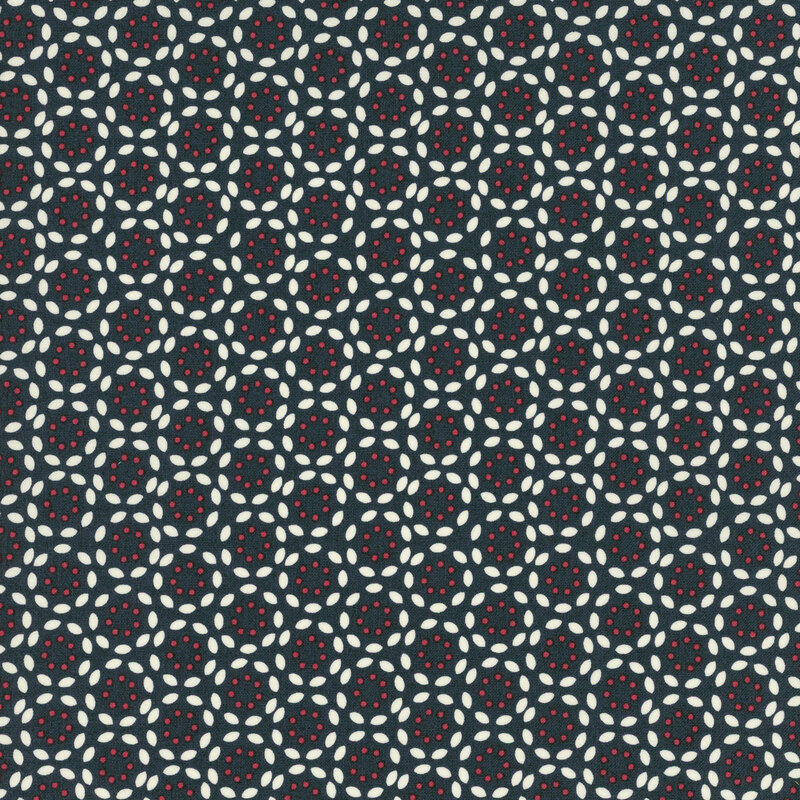 navy blue fabric featuring a repeating white petal pattern surrounding a red circle of dots