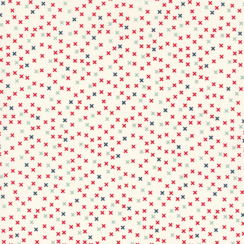 cream fabric featuring a scattered x pattern in red, navy blue, and aqua