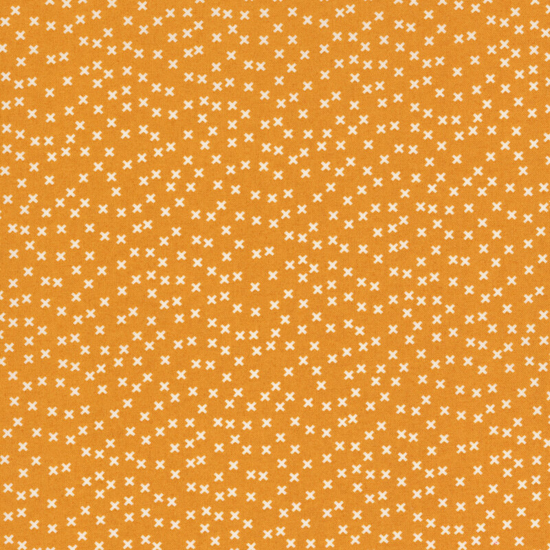 mustard yellow fabric featuring a scattered white x pattern