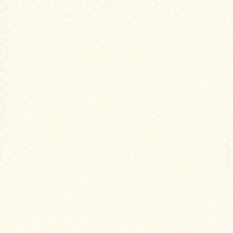 cream tonal fabric featuring a scattered white x pattern