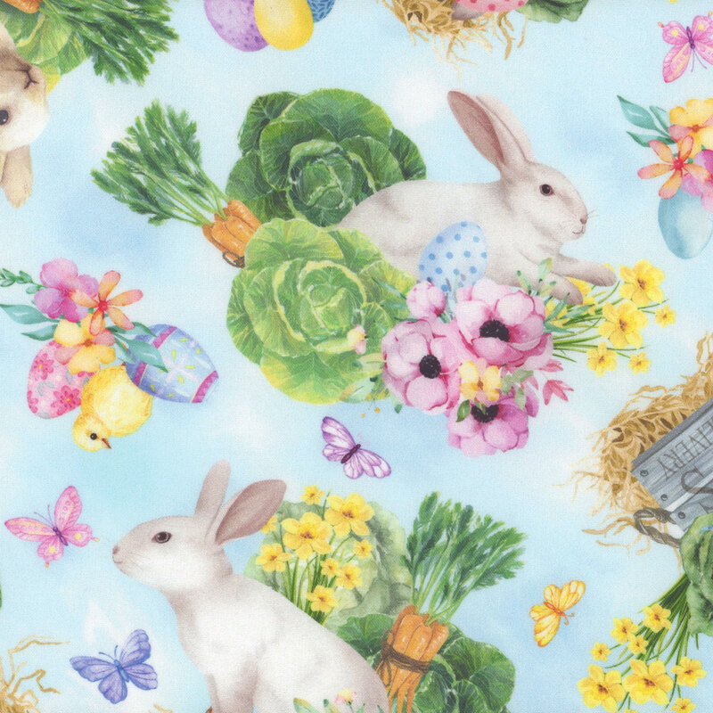 mottled blue fabric with white rabbits, Easter decor, and vegetables tossed all over
